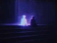 b0yblitz_two_brightly_glowing_ghostly_figures_sitting_on_dark_s_6883329c-d68a-4838-8646-d7b1588ad94f